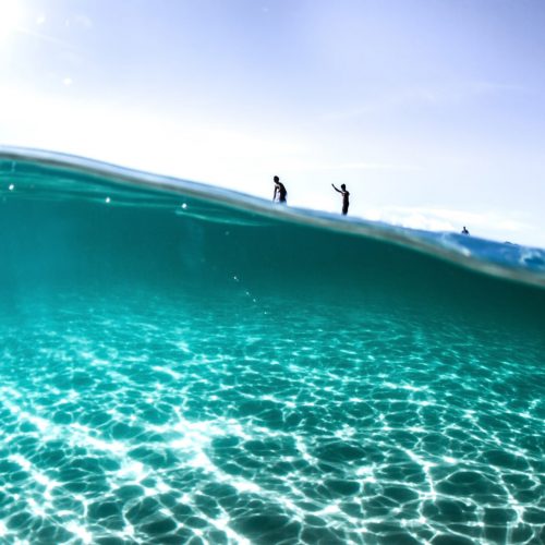 looking-underwater-to-surfers-on-wave